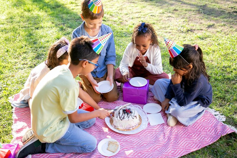Crianças a celebrar um aniversário com piquenique ao ar livre